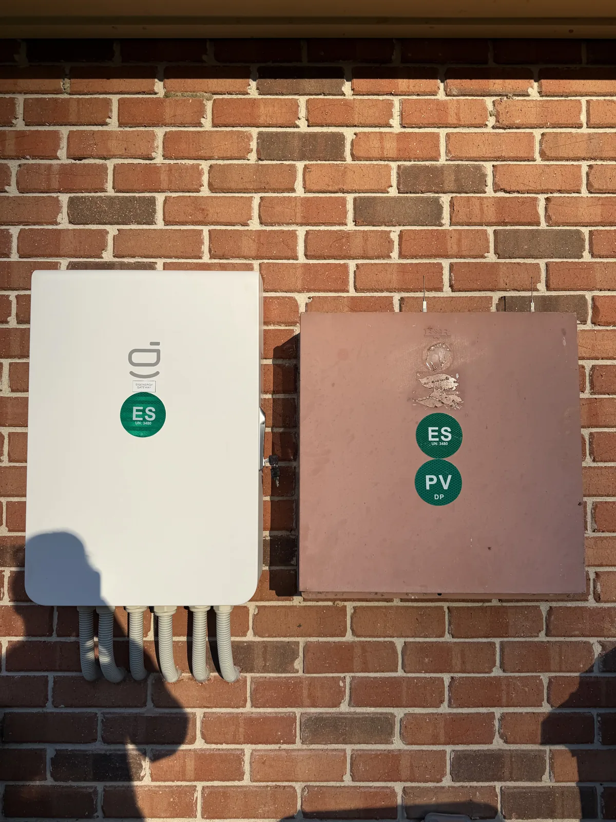 Inverter and switchboard mounted on the brick exterior wall at Bonalbo