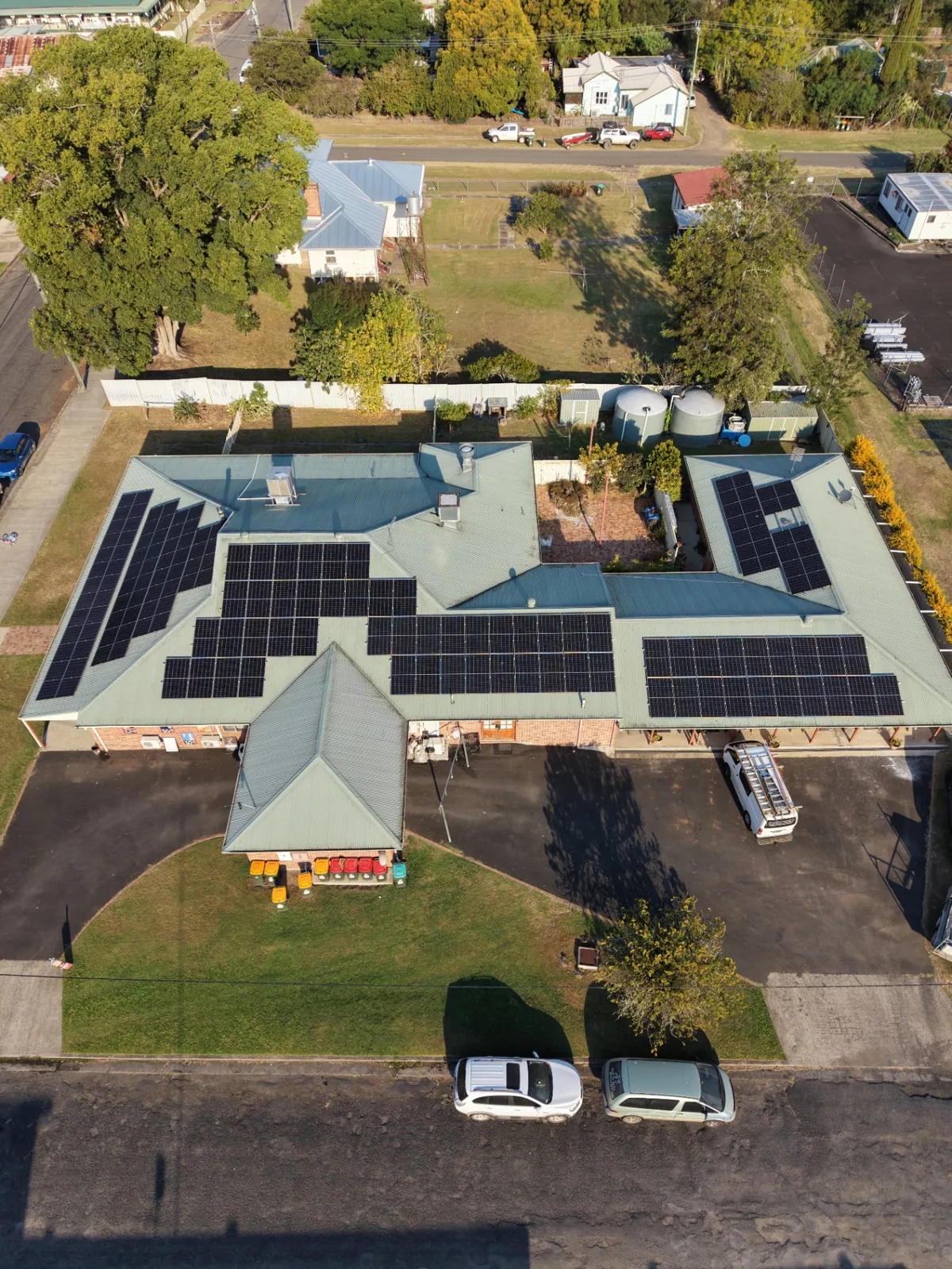 Wide aerial view of the Dog N' Bull Hotel solar install with the HJP van on site, Bonalbo NSW